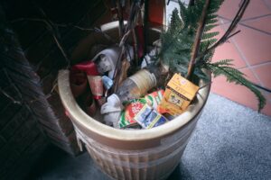 A potted plant with a bunch of garbage in it