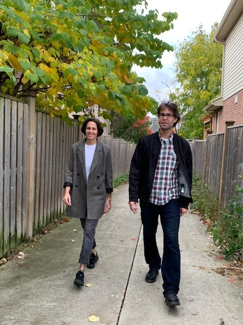 Tyler and Carrie walking down alley.