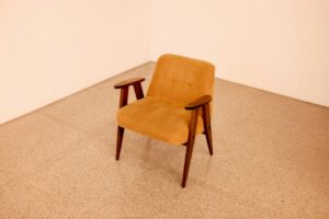 brown wooden framed beige padded chair