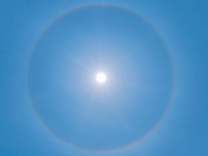 blue sky with white sun