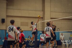 A group of people playing a game of volleyball